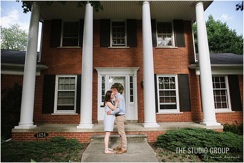 Couple stands in front of their beautiful Royal Oak home