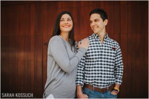 Downtown Birmingham, red wood wall, couple poses