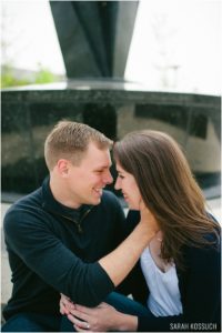 Couple embraces in front of fountain