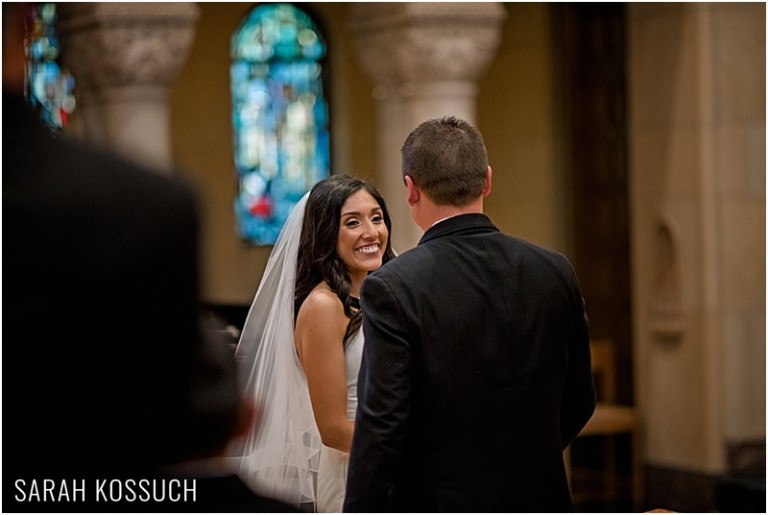 Bride smiling at father during ceremony