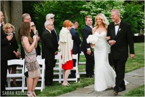 Bride walks down aisle, outdoor ceremony