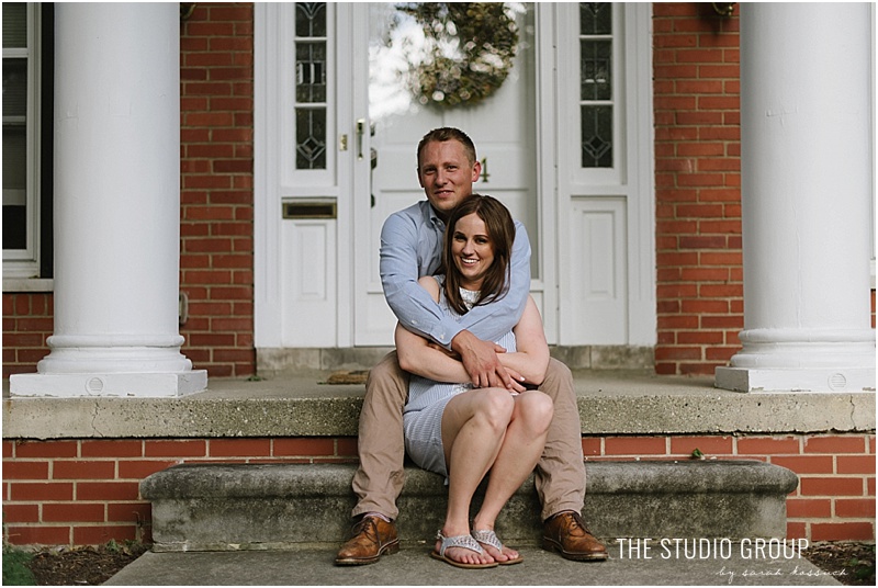 Couple sit on steps at Royal Oak home