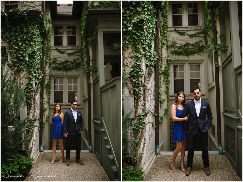 Sunglasses and suits, couple standing in alley